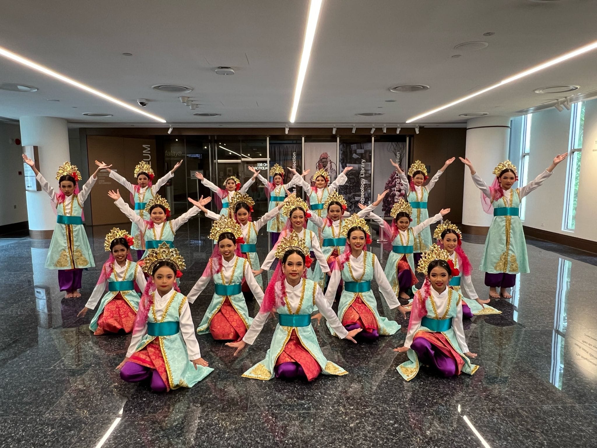 Students in a group photo showing their joy after performing a Malay dance number